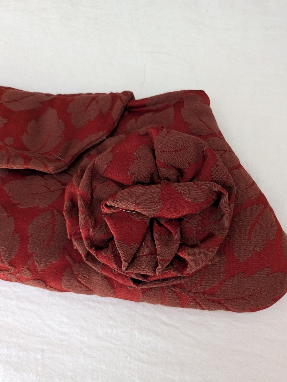 Elegant Red Floral Jacquard Clutch with Rosette Accent